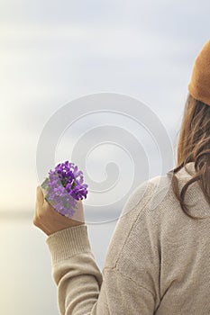 Spring time, woman holds a bouquet of colorful flowers in her hand