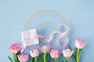 Spring tulip flowers, gift or present box and number 8 for Happy Women Day. Greeting card on blue background