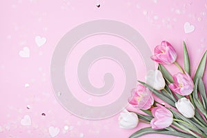 Spring tulip flowers on pastel pink background top view. Greeting card for International Women Day, Mother day. Flat lay photo