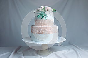 Spring two-tiered cake decorated with roses from mastic top