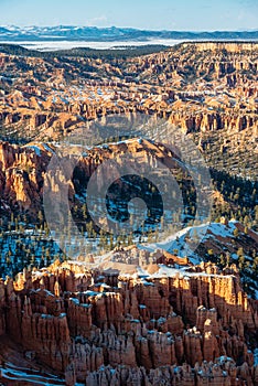 Spring view of Bryce Amphitheater in snow from Sunrise Point at sunset photo