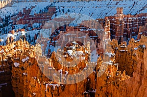 Spring view of Bryce Amphitheater in snow from Sunrise Point at sunset photo