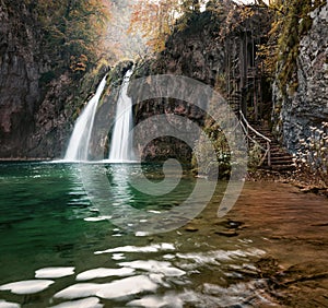 Spring water flowing down in waterfall in deep canyon. Impressive autumn scene of Plitvice National Park, Croatia, Europe. Abandon