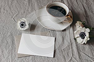 Spring wedding stationery mock-up scene. Blank greeting card, envelope on beige linen tablecloth background. White