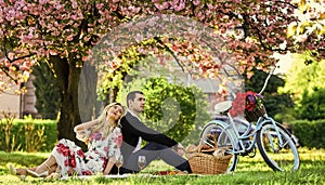 Spring weekend. Romantic picnic with wine. Give uncommon, unique gifts spontaneously. Happy loving couple relaxing in