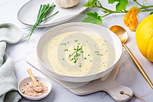 Spring white creamy zucchini soup with herbs