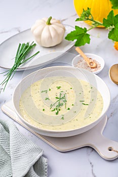 Spring white creamy zucchini soup with herbs