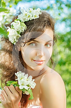 Spring Woman.Beautiful Girl model with spring flowers. Young Fem