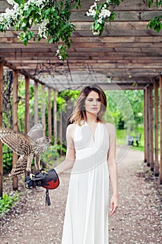 Spring woman with bird outdoors fashion portrait