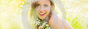 Spring woman face for banner. Portrait of a beautiful young girl in the spring with wildflowers. Happy summer face of