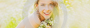 Spring woman face for banner. Portrait of a beautiful young girl in the spring with wildflowers. Happy summer face of