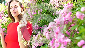 Spring woman in flower park. Girl rose garden. Summer nature.