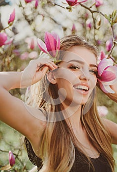 Spring woman with flowers. Happy spring holiday. Blooming. Beautiful girl with pink flowers. Beauty day in spring. Happy