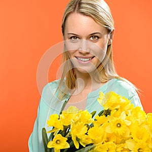 Spring woman hold yellow narcissus flowers