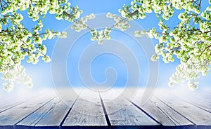 Spring wooden table or floor with blossoms . Empty space for presentation product on floral background