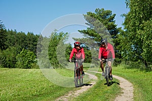 Spring - Young couple cycling in a nature