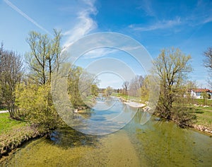 Springlike landscape mangfall river, village beside the riverside, blue sky