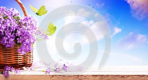 Springtime banner background. bluebells spring flowers in a basket and fly butterfly