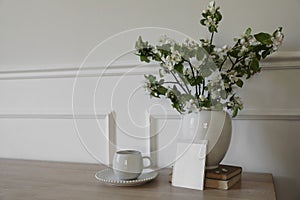 Springtime breakfast still life. Empty greeting card, invitation mockup. White ceramic vase with blooming apple tree