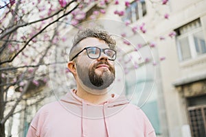 Springtime concept. Bearded man on background bloom of magnolia. Spring beauty season. Botany and nature. Happy spring