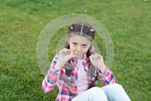 Springtime concept. Park and garden. Kid gadabout. Girl little kid spend leisure outdoors in park. Girl sit on grass in