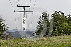 Springtime forest with glade, residential district and old electric power transmission line, Plana mountain