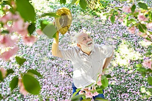 Springtime. old man imagining beautiful good things to realize further. mature man looking up with hope. happy man under