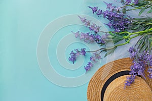 Springtime summer time lavender flowers blue background lady hat copy space top view