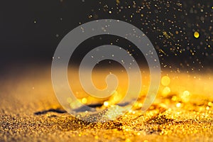 Sprinkle gold dust on a black background