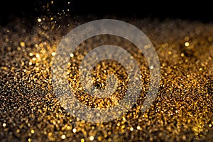 Sprinkle gold dust on a black background