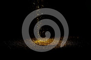 Sprinkle gold dust on a black background