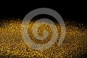 Sprinkle gold dust on a black background