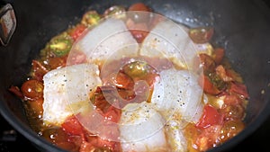 Sprinkle with pepper and spices traditional Sicilian fish with tomatoes