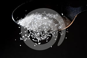 A sprinkle of salt from a spoon photo