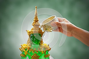 Sprinkle water onto the Emerald Buddha in songkran festival