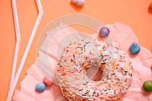 Sprinkled Pink Donut. Frosted sprinkled donut on pink background.