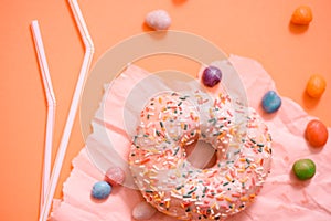 Sprinkled Pink Donut. Frosted sprinkled donut on pink background.