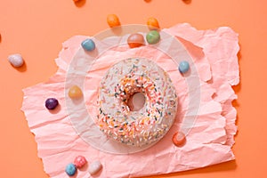 Sprinkled Pink Donut. Frosted sprinkled donut on pink background.