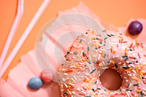 Sprinkled Pink Donut. Frosted sprinkled donut on pink background.