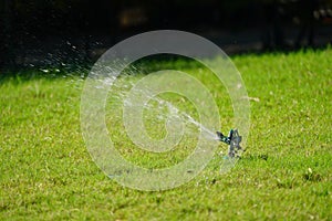 Sprinkler grass working system, working on the field in the garden