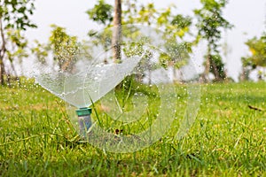 Sprinkler spraying water on the grass.