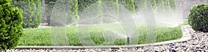 Sprinklers watering lawn in garden