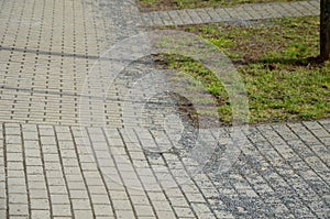 Sprinkling icing on the sidewalk needs to be cleaned after winter and swept away. the sidewalk of concrete pavement in the new dis