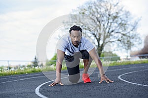 Sprint athlete on the track in on your mark position
