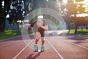 Sprinter leaving starting blocks on the running track. Explosive start.