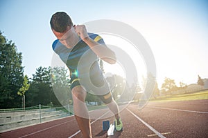 Sprinter leaving starting blocks on the running track. Explosive start.