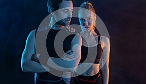Sprinter run. Strong athletic woman and man rest after running on black background. Fitness and sport motivation. Runner