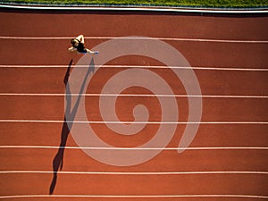 Sprinter running on athletics tracks seen from above