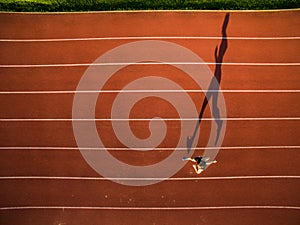 Sprinter running on athletics tracks seen from above