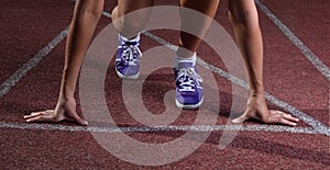 Sprinter waiting for start of race. Running tracks at outdoor stadium. Sport and fitness with running shoes